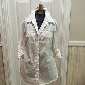 White button down top with roll tan sleeves. Tunic length